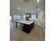 Open kitchen features a large island, stainless steel appliances, and great natural light at 10039 S 23Rd Dr, Phoenix, AZ 85041