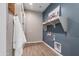 Well-organized laundry room with gray walls, shelving, and modern appliance connections at 10039 S 23Rd Dr, Phoenix, AZ 85041