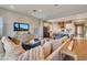 Cozy living room with shiplap wall, large sectional sofa, and an open view to the gourmet kitchen at 10039 S 23Rd Dr, Phoenix, AZ 85041