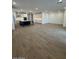 Open-concept living room showcases hardwood flooring with an adjoined modern kitchen at 10039 S 23Rd Dr, Phoenix, AZ 85041