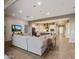 Bright, open-concept living room with wood floors connecting to kitchen and a large sofa at 10039 S 23Rd Dr, Phoenix, AZ 85041