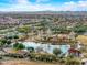 Aerial view of a community park featuring a lake, walking path, and outdoor pavilion at 10249 E Kinetic Dr, Mesa, AZ 85212