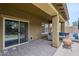 Comfortable covered back patio with wicker sofa set and access to backyard at 10249 E Kinetic Dr, Mesa, AZ 85212