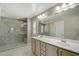 Well lit bathroom featuring double sinks, spacious tiled shower and neutral color palette at 10249 E Kinetic Dr, Mesa, AZ 85212