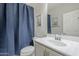 Bathroom featuring a sink vanity, mirror, toilet, and a blue shower curtain at 10249 E Kinetic Dr, Mesa, AZ 85212