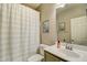 Bright bathroom featuring a tub with shower and single sink vanity at 10249 E Kinetic Dr, Mesa, AZ 85212