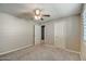 Neutral bedroom features carpet flooring, a ceiling fan and two closets at 10249 E Kinetic Dr, Mesa, AZ 85212