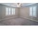 Neutral bedroom with carpeting, shuttered windows, and recessed lighting at 10249 E Kinetic Dr, Mesa, AZ 85212