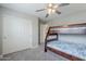 Bright bedroom with a bunk bed, ceiling fan, and closet at 10249 E Kinetic Dr, Mesa, AZ 85212