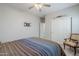 Bedroom with a ceiling fan, closet, and an accent chair at 10249 E Kinetic Dr, Mesa, AZ 85212
