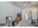 Cozy bedroom featuring a ceiling fan, gray carpet, and ample space at 10249 E Kinetic Dr, Mesa, AZ 85212