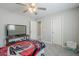 Cozy bedroom with a television, ceiling fan, and closet at 10249 E Kinetic Dr, Mesa, AZ 85212