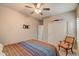 Cozy bedroom with ceiling fan, closet and TV mount at 10249 E Kinetic Dr, Mesa, AZ 85212