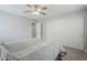Bedroom with ceiling fan, closet, and comfortable bedding at 10249 E Kinetic Dr, Mesa, AZ 85212