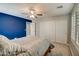 Bedroom with accent wall, ceiling fan and double door closet at 10249 E Kinetic Dr, Mesa, AZ 85212