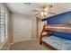 Bedroom featuring a bunk bed, blue accent wall and closet at 10249 E Kinetic Dr, Mesa, AZ 85212