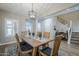 Bright dining room featuring a wooden table, chandelier, and staircase at 10249 E Kinetic Dr, Mesa, AZ 85212