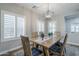 Bright dining room with natural light, a wooden table, and stylish chandelier at 10249 E Kinetic Dr, Mesa, AZ 85212