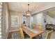 Well-lit dining room featuring a wooden table and chairs with a modern light fixture and a clear view to the foyer at 10249 E Kinetic Dr, Mesa, AZ 85212