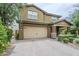 Charming two-story home featuring a well-maintained lawn and a two-car garage at 10249 E Kinetic Dr, Mesa, AZ 85212