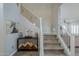 Inviting foyer with decorative stairway, sports bar cabinet, and access to the living room at 10249 E Kinetic Dr, Mesa, AZ 85212