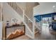 Stylish foyer with an eye-catching staircase and direct views into the living area with its blue accent wall at 10249 E Kinetic Dr, Mesa, AZ 85212