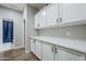 Hallway with updated cabinets and countertops leading to the bathroom with shower at 10249 E Kinetic Dr, Mesa, AZ 85212