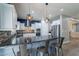 Modern kitchen featuring an island with bar seating, white cabinets, and stainless steel appliances at 10249 E Kinetic Dr, Mesa, AZ 85212