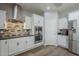 Updated kitchen with stainless steel appliances, granite counters, and a decorative tile backsplash at 10249 E Kinetic Dr, Mesa, AZ 85212
