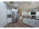 Open-concept kitchen with stainless steel appliances and a view into the living room at 10249 E Kinetic Dr, Mesa, AZ 85212