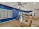 Inviting living room with stylish blue accent wall, comfortable seating, and seamless access to the modern kitchen at 10249 E Kinetic Dr, Mesa, AZ 85212