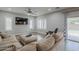 Cozy living room with modern decor, a large sectional, and sliding glass doors to the backyard at 10249 E Kinetic Dr, Mesa, AZ 85212