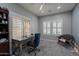 Office space with natural light, neutral colors, a wooden desk, and shuttered windows at 10249 E Kinetic Dr, Mesa, AZ 85212