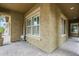 Inviting outdoor patio featuring stylish pavers, stucco walls, and bright windows at 10249 E Kinetic Dr, Mesa, AZ 85212