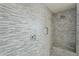 Spa-like shower with horizontally laid tile, chrome fixtures, and built-in shower seat at 10249 E Kinetic Dr, Mesa, AZ 85212