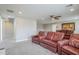 View of the theater room with comfortable seating, ceiling fan, and access to the hallway at 10249 E Kinetic Dr, Mesa, AZ 85212