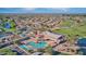 Aerial view showcases community center with a pool, mature trees, a golf course, tennis courts, and beautiful landscaping at 10410 E San Tan Blvd, Sun Lakes, AZ 85248