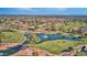 Beautiful aerial view of the golf course with mature trees and water features in a lovely community with mountain views at 10410 E San Tan Blvd, Sun Lakes, AZ 85248