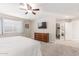 Bedroom featuring a ceiling fan, dresser, and an entrance to a walk-in closet at 10410 E San Tan Blvd, Sun Lakes, AZ 85248