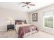 Bedroom with plush carpet flooring, ceiling fan, and picture window at 10410 E San Tan Blvd, Sun Lakes, AZ 85248