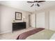 Bedroom with tan walls, black dresser with flowers, and carpeted floors at 10410 E San Tan Blvd, Sun Lakes, AZ 85248