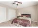 Cozy bedroom with a ceiling fan, carpeted floors, and neutral decor at 10410 E San Tan Blvd, Sun Lakes, AZ 85248