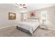 Well-lit bedroom with a ceiling fan and plush carpet flooring at 10410 E San Tan Blvd, Sun Lakes, AZ 85248