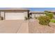 Charming home featuring desert landscaping and a paved walkway to a red front door at 10410 E San Tan Blvd, Sun Lakes, AZ 85248