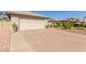 Spacious driveway leads to the two-car garage with desert landscaping accents at 10410 E San Tan Blvd, Sun Lakes, AZ 85248