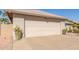 Home featuring a clean, two-car garage and desert landscaping at 10410 E San Tan Blvd, Sun Lakes, AZ 85248