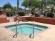 Relaxing hot tub with tile accents and easy access steps surrounded by mature plants at 10410 E San Tan Blvd, Sun Lakes, AZ 85248