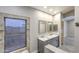 Bathroom featuring double vanity, marble counters, tiled shower, and natural lighting at 1086 S Western Skies Dr, Gilbert, AZ 85296