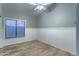 An empty bedroom with wood-look floors and a large window with blinds at 1086 S Western Skies Dr, Gilbert, AZ 85296