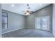 A neutral bedroom features carpet, a ceiling fan, and glass doors to the backyard at 1086 S Western Skies Dr, Gilbert, AZ 85296